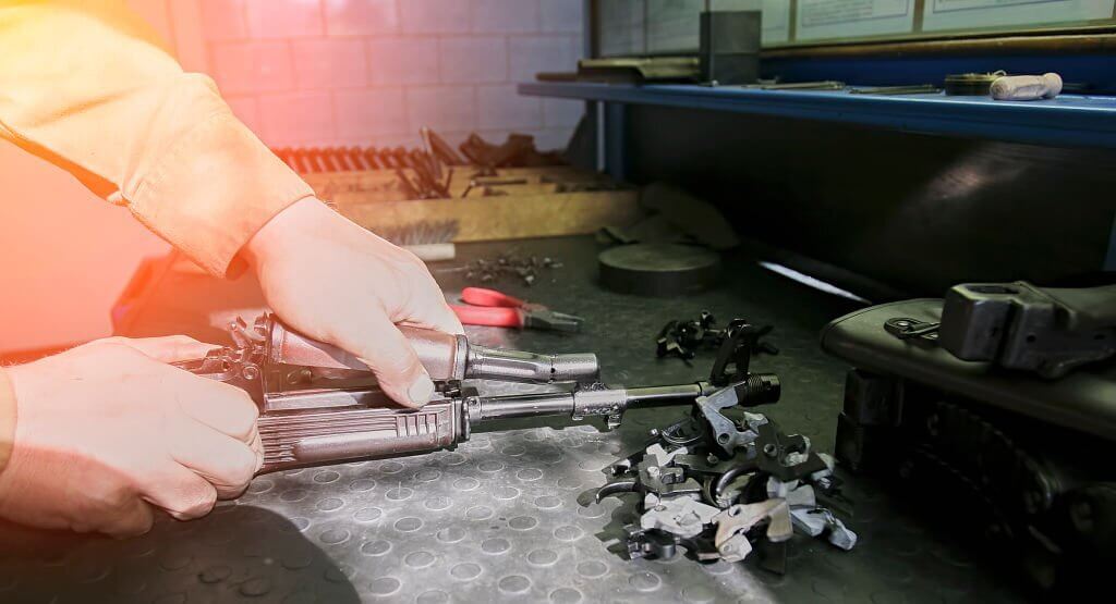 A gunsmith repairing a firearm closeup