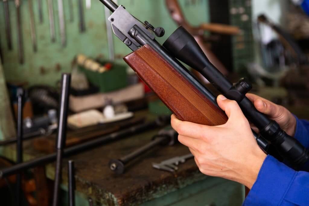 A gunsmith repairing a gun closeup