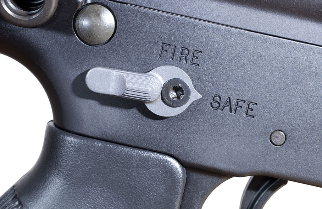 Close up image of a gun safety in the safe position