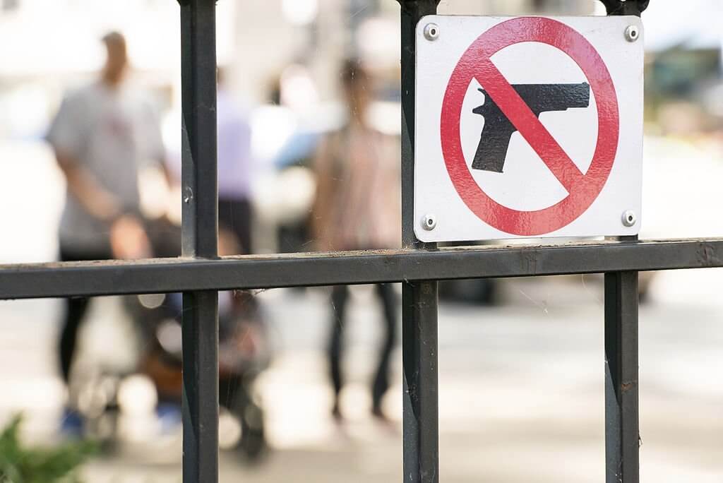 A no guns sign on a school gate