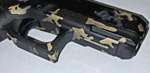 A firearm with a camouflage cerakote