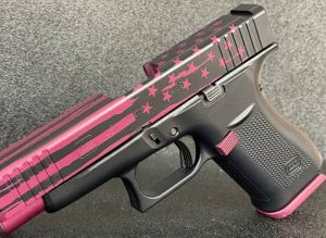A firearm with a pink stars and stripes cerakote