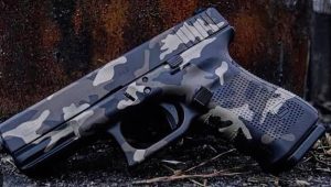 A firearm with a grey camouflage cerakote