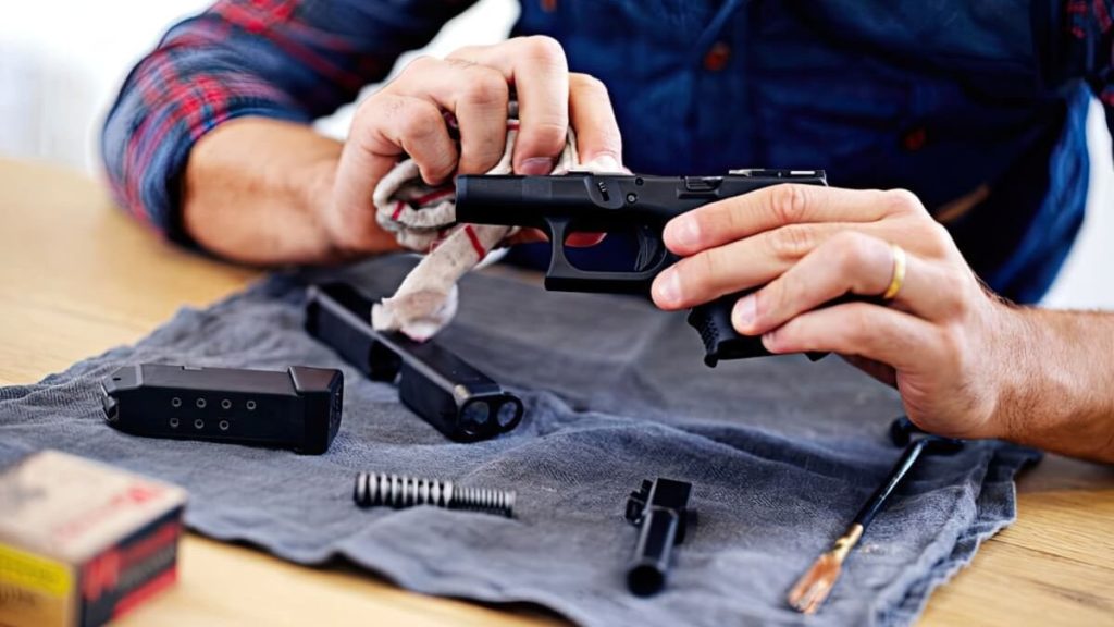 A man cleaning his handgun