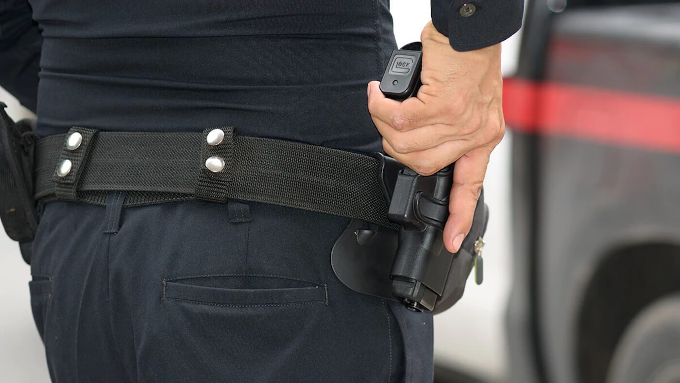 A police officer using an OWB holster