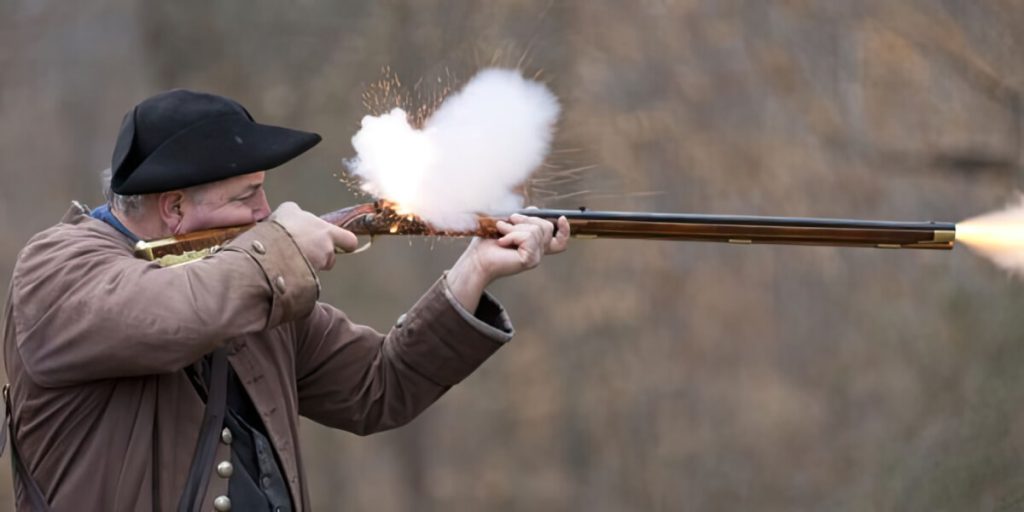 a man in uniform firing a musket