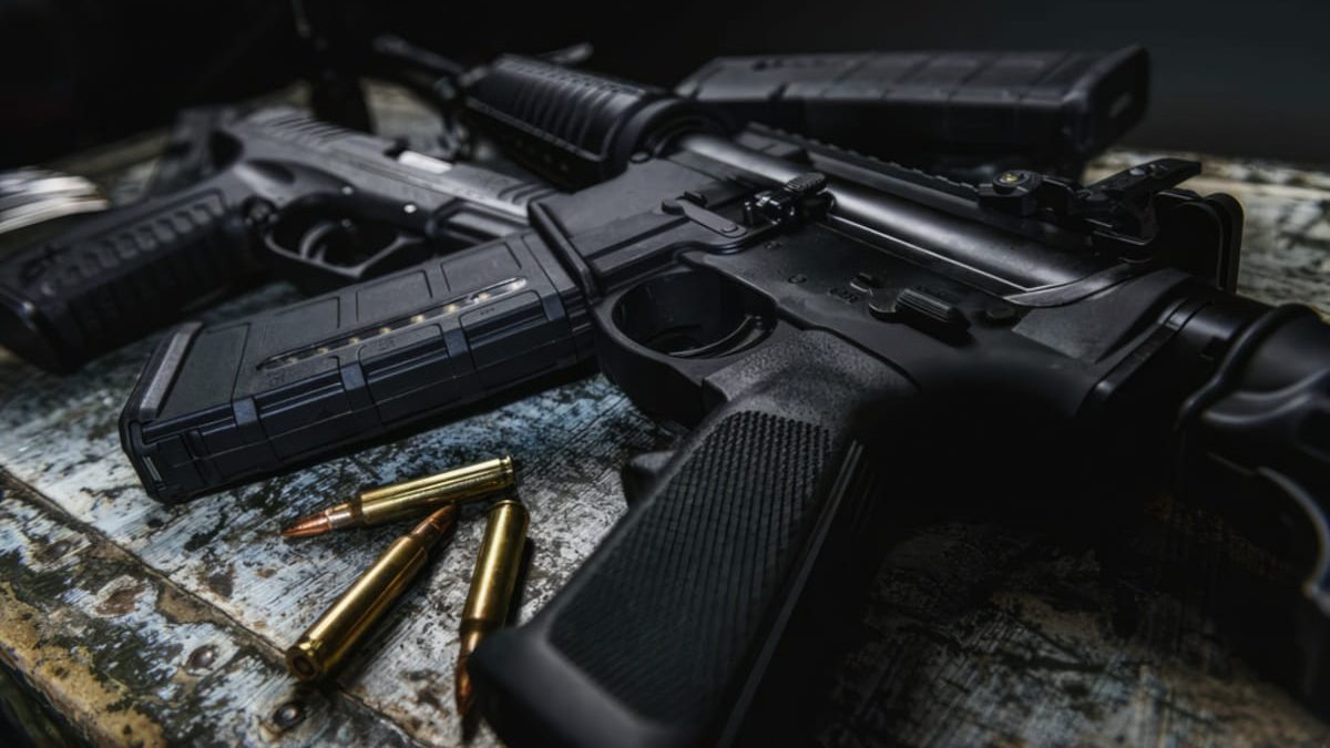 An Assault Rifle On A Wooden Table With Bullets 1